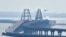 Un helicóptero arroja agua sobre el puente que conecta la península de Crimea con el territorio continental ruso sobre el estrecho de Kerch.