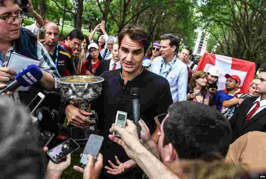 El suizo Roger Federer responde a las preguntas de los medios de comunicación después de una sesión de fotos con el trofeo ganado en el Abierto de Australia en el Carlton Gardens de Melbourne, Australia, el 30 de enero de 2017. Federer derrotó al español Rafael Nadal en el partido final.  