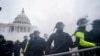 Partidarios de Trump intentan atravesar una barrera policial en el Capitolio de Washington. (AP/Julio Cortez).